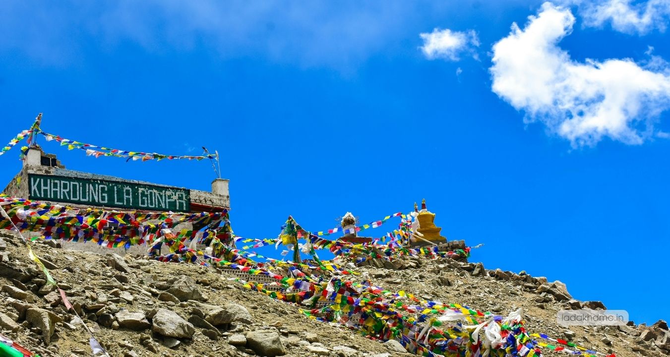 Panoramic view of Khardung La with winding roads, mountain peaks, and scenic Ladakh landscape