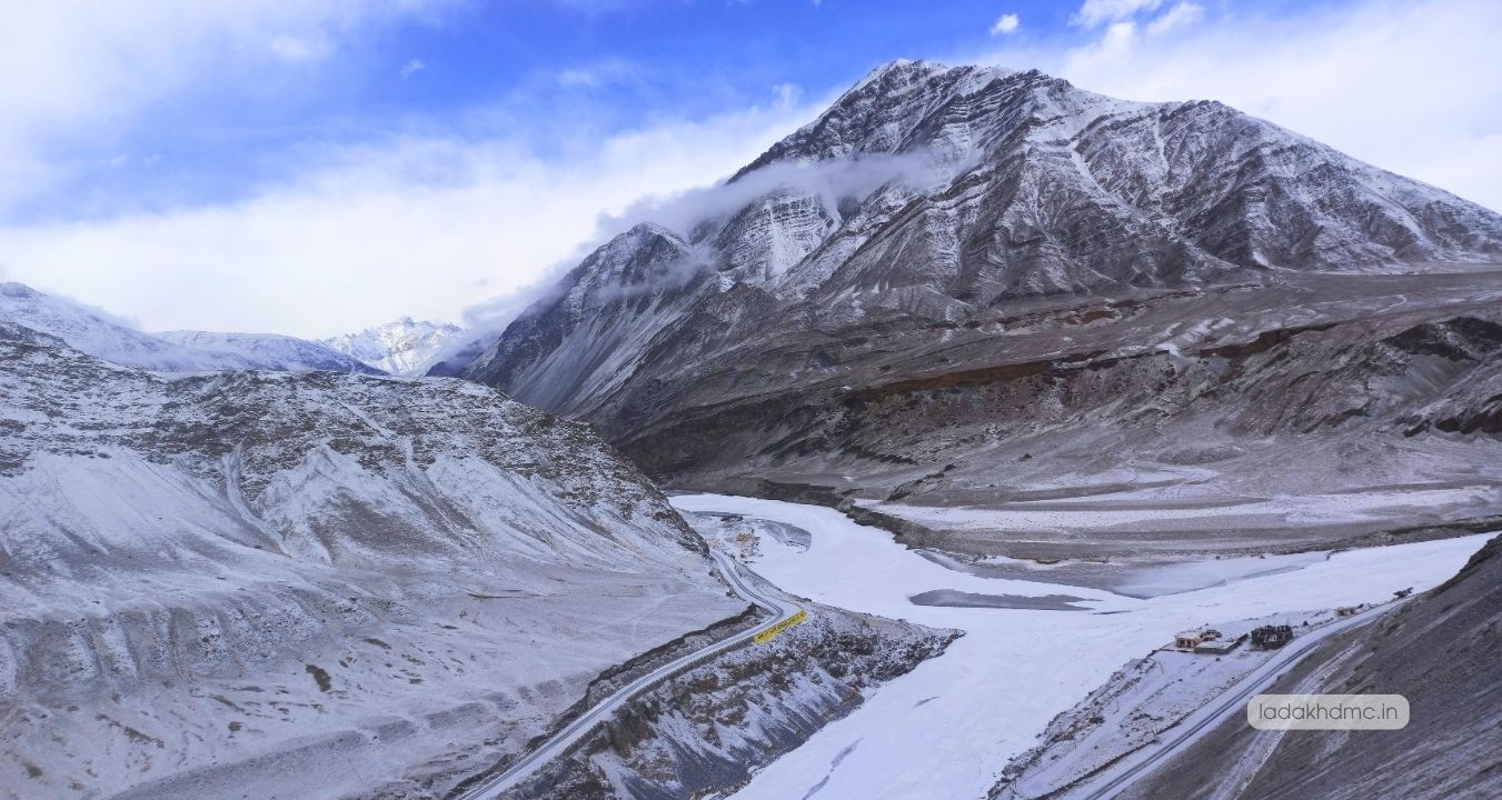 Khardung La pass surrounded by majestic Himalayan mountains and valleys in Ladakh