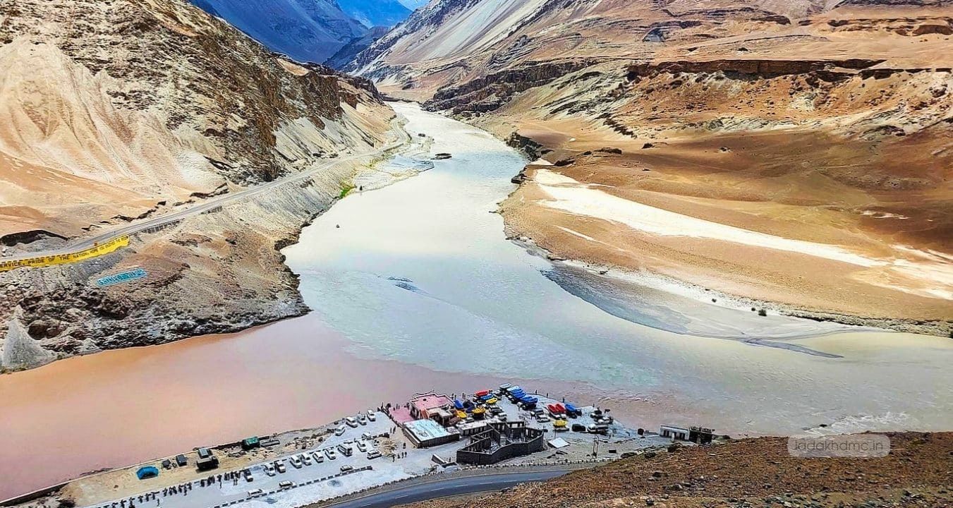 Panoramic view of Sangam Point with winding roads, mountain peaks, and Himalayan landscape in Ladakh