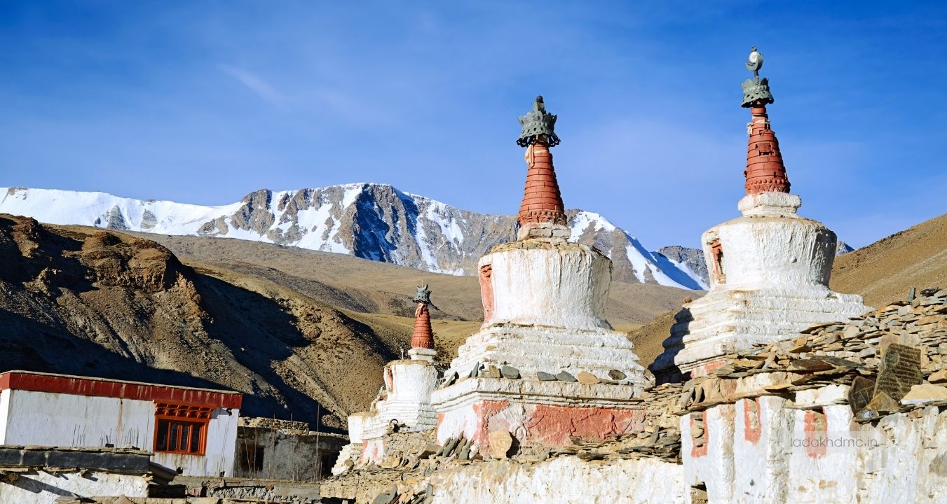 Interior prayer hall with monks and Buddhist artifacts at Stok Monastery in Leh, Ladakh