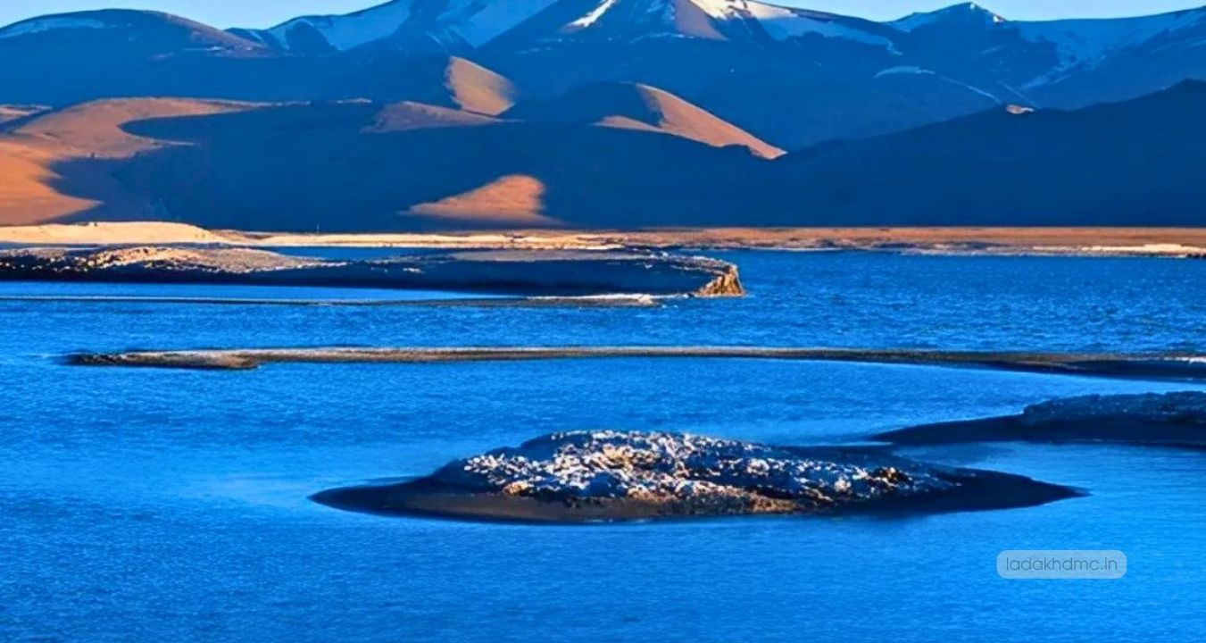 Panoramic view of Mirpal Tso Lake with turquoise waters and snow-capped Himalayan peaks in Leh Ladakh