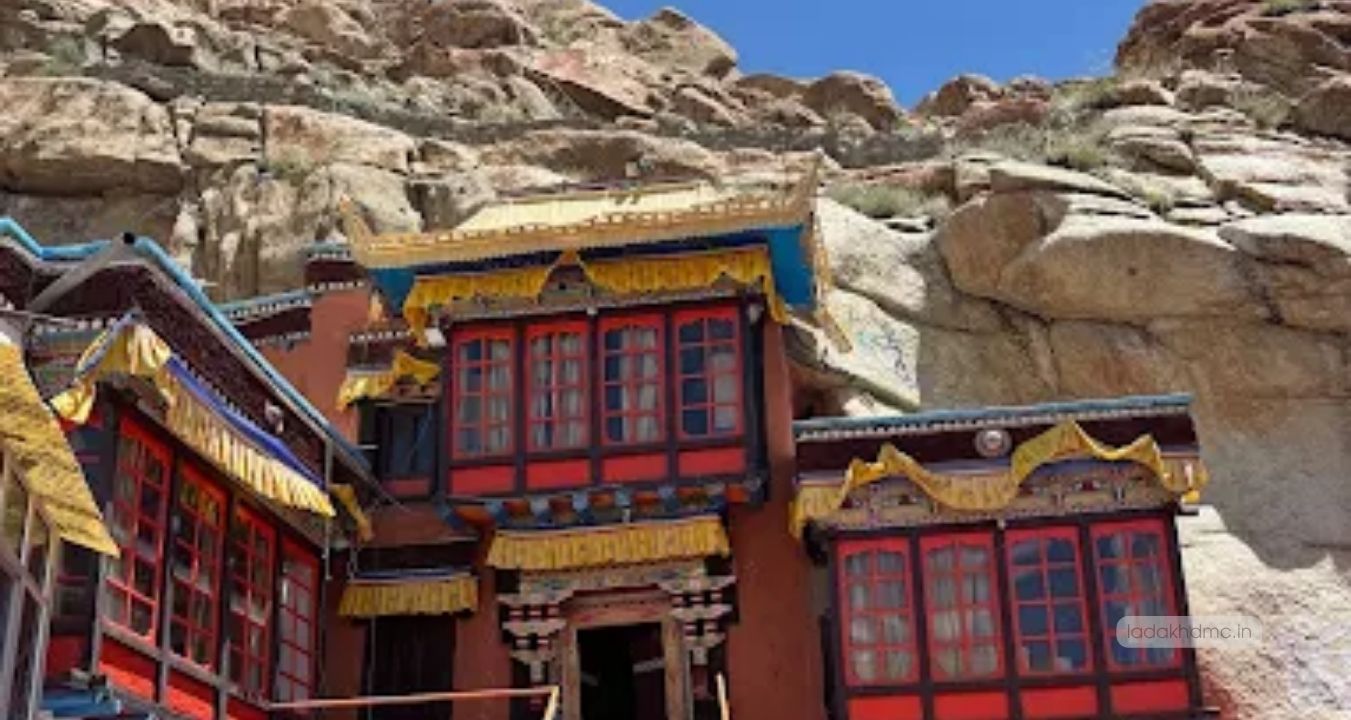 Interior prayer hall with monks and Buddhist artifacts at Stok Monastery in Leh, Ladakh