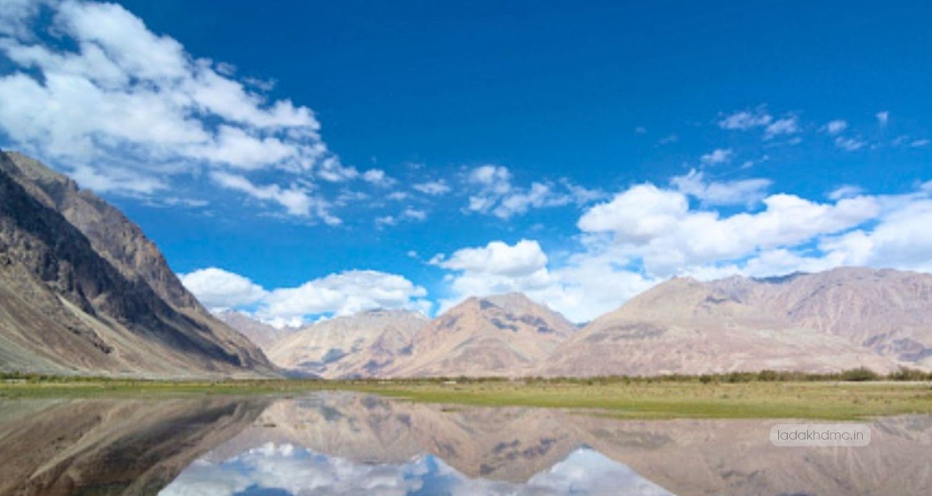 Sacred Yarab Tso Lake surrounded by rugged mountains and pristine Himalayan scenery in Nubra Valley